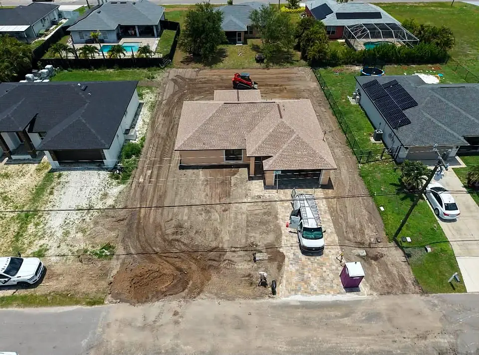Aerial view of a filled and graded lot around a new home
