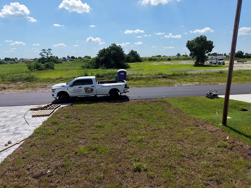 New sod lawn along a street with a white pickup truck parked